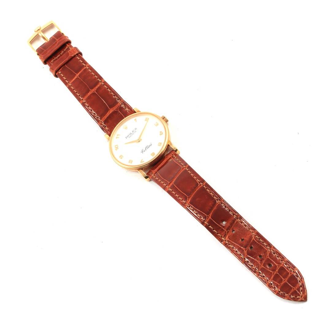 The image shows a top-down view of a Rolex Cellini 5115 Yellow Gold Mother of Pearl Dial 5115 Yellow Gold Mother of Pearl Dial watch with a brown leather strap and a gold case.