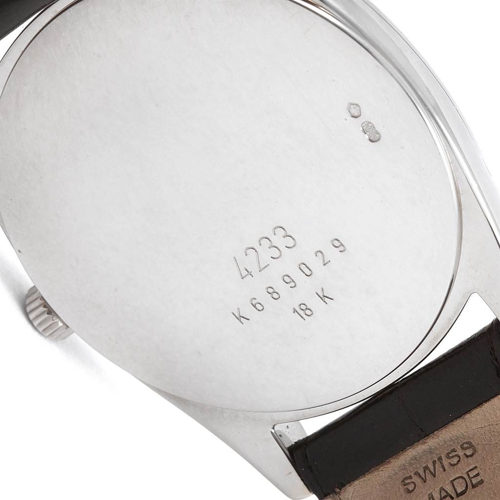 This image shows the back case of a Rolex Cellini 4233 Men's White Gold White Dial 4233 Men's White Gold White Dial watch, revealing the model number 4233, serial number, and strap in close-up.