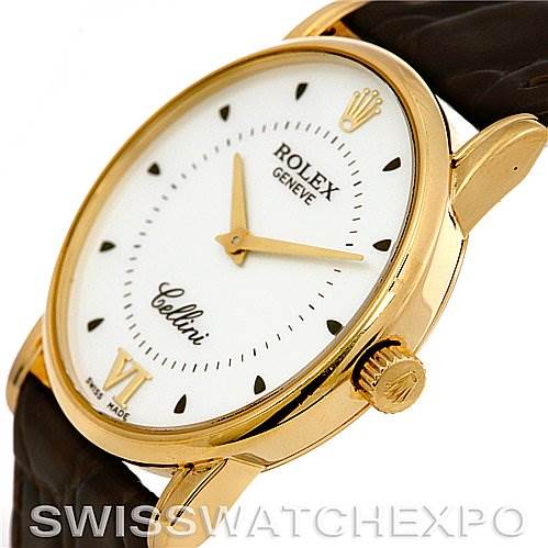 The Rolex Cellini 5116 Yellow Gold Silver Dial 5116 Yellow Gold Silver Dial watch is shown at an angle highlighting the watch face, gold-toned case, crown, and part of the brown leather strap.