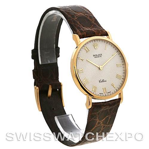 The Rolex Cellini 5112 Yellow Gold Beige Dial 5112 Yellow Gold Beige Dial watch is shown at a three-quarter angle, highlighting its gold case, white dial, and brown leather strap.