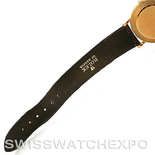 The image shows the strap and back of the case of a Rolex Cellini 5112 Yellow Gold Beige Dial 5112 Yellow Gold Beige Dial watch, focusing on the branding on the strap.