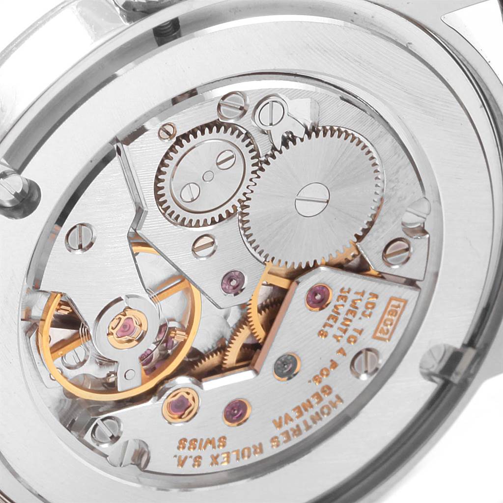 The image shows the inner mechanical movement of a Rolex Cellini 5115 Men's White Gold Silver Dial 5115 Men's White Gold Silver Dial watch, highlighting gears and intricate components.