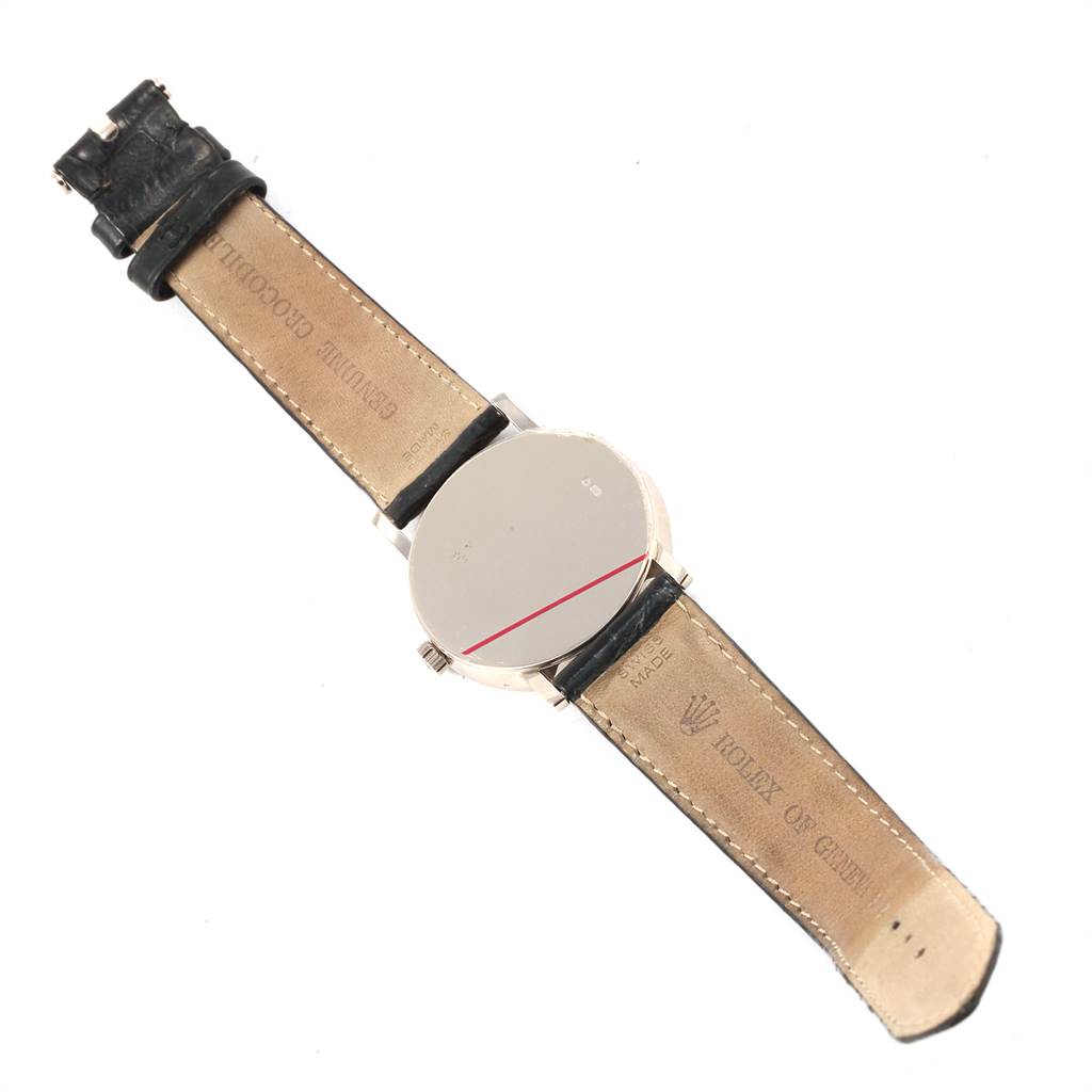 The image shows the back side of a Rolex Cellini 5115 Men's White Gold Silver Dial 5115 Men's White Gold Silver Dial watch, including its leather straps and the watch case back.