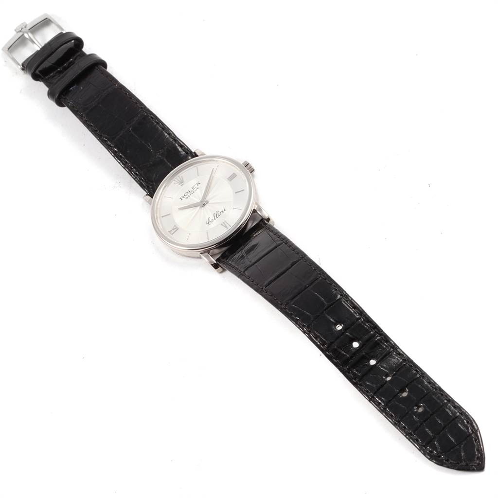 The image shows an overhead view of a Rolex Cellini 5115 Men's White Gold Silver Dial 5115 Men's White Gold Silver Dial watch featuring a black leather strap and silver watch face.