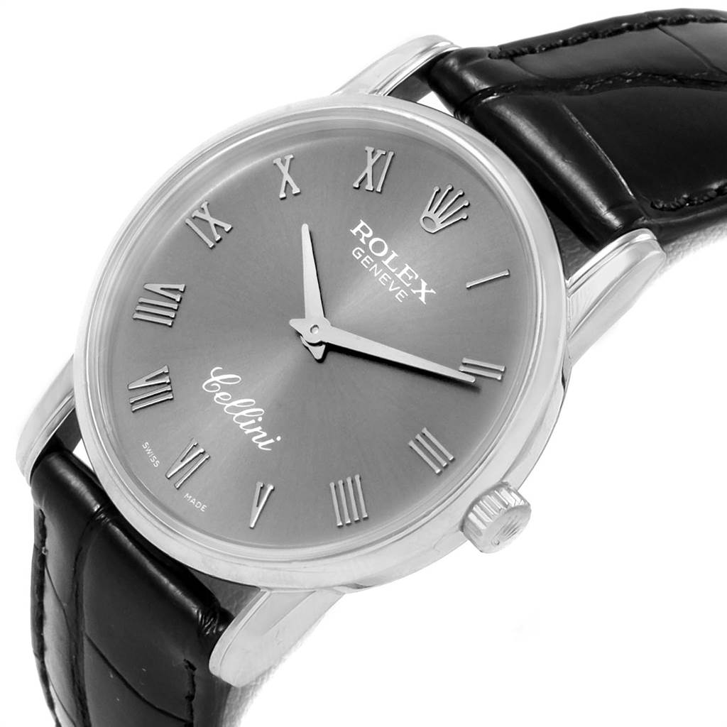 The image shows a close-up of a Rolex Cellini 5116 Men's White Gold Grey Dial 5116 Men's White Gold Grey Dial watch face and part of its black leather strap at an angle.