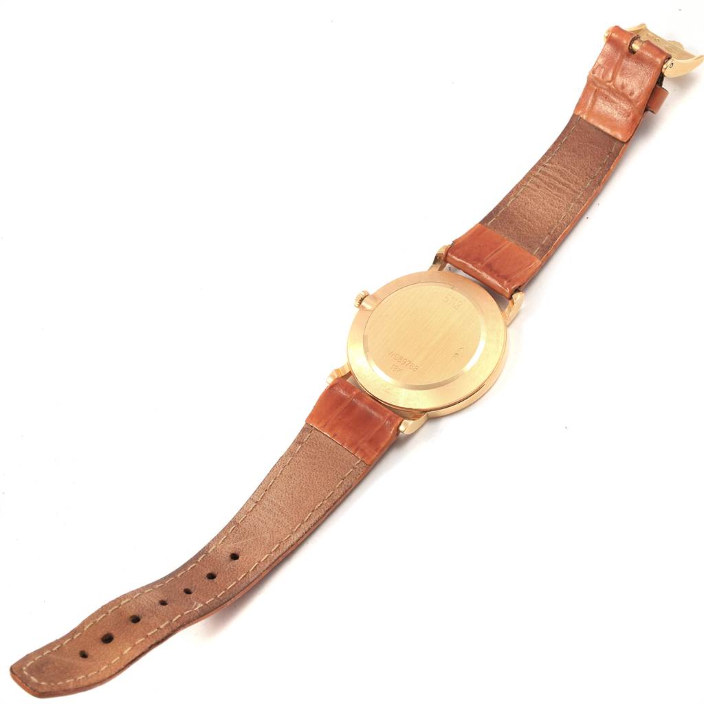 This image shows the back of the Rolex Cellini 5112 Men
s Yellow Gold Beige Dial 5112 Men
s Yellow Gold Beige Dial watch with a brown leather strap, photographed from above.