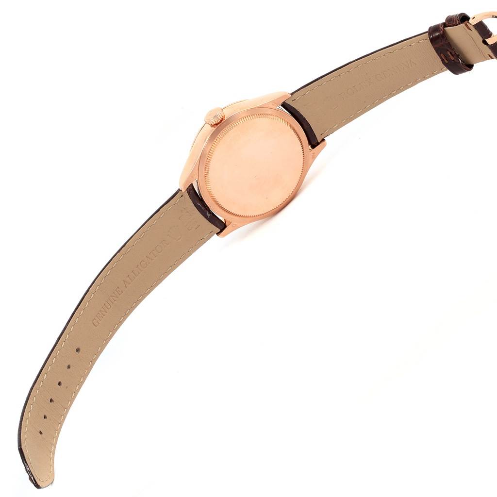 The image shows the back and strap of a Rolex Cellini 50525 Men
s Rose Gold Silver Dial 50525 Men
s Rose Gold Silver Dial watch, displaying its gold case and leather band.