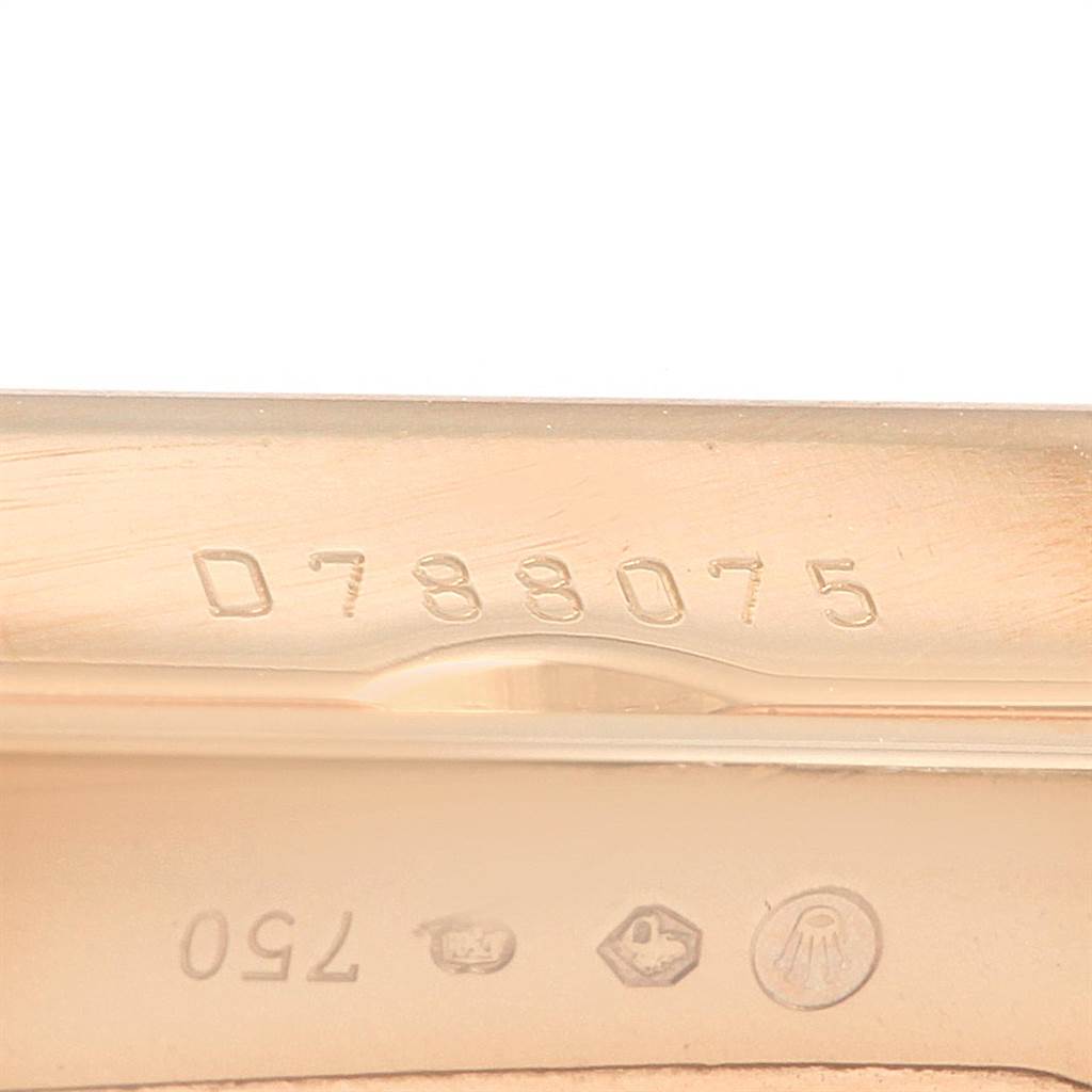 This image shows a close-up of the serial number and hallmark engravings on a Rolex Cellini 5442/5 Men's Rose Gold Black Dial 5442/5 Men's Rose Gold Black Dial model.