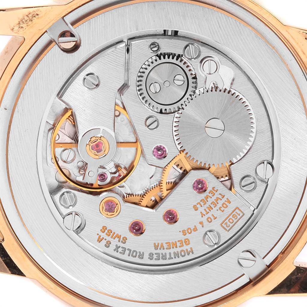 The image shows the back view of a Rolex Cellini 5116 Men's Yellow Gold Champagne Dial 5116 Men's Yellow Gold Champagne Dial watch, highlighting its intricate movement and mechanical parts.