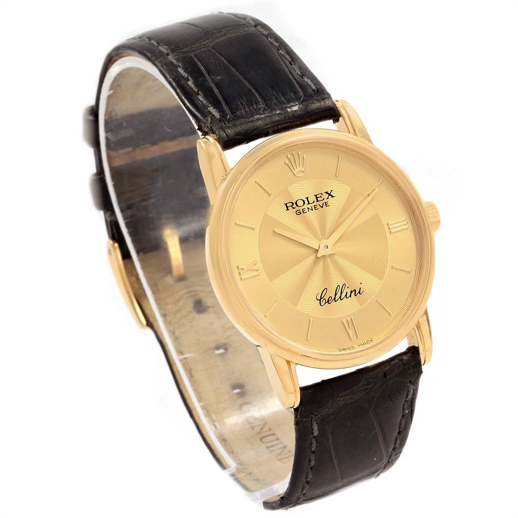 The image shows a Rolex Cellini 5116 Men's Yellow Gold Champagne Dial 5116 Men's Yellow Gold Champagne Dial watch angled from the front and left side, featuring a gold case and a black leather strap.