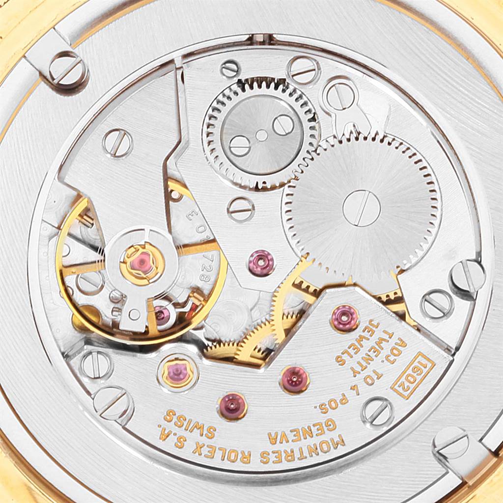 The image shows a close-up of the movement mechanism of a Rolex Cellini 4233 Men's Yellow Gold White Dial 4233 Men's Yellow Gold White Dial watch, highlighting gears and intricate details.
