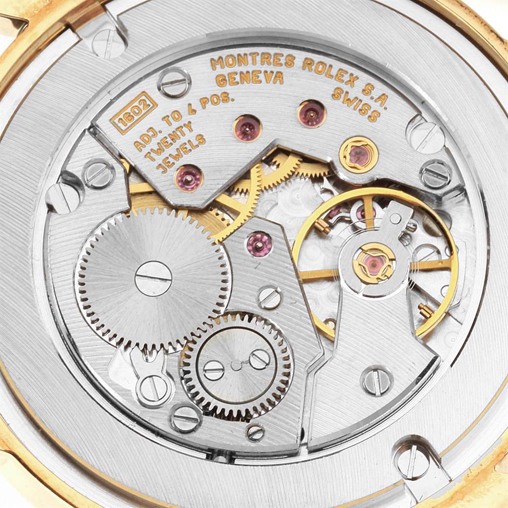 The image shows the internal mechanism of a Rolex Cellini 5116 Men's Yellow Gold Grey Dial 5116 Men's Yellow Gold Grey Dial watch from a top-down angle, highlighting gears and jewels.