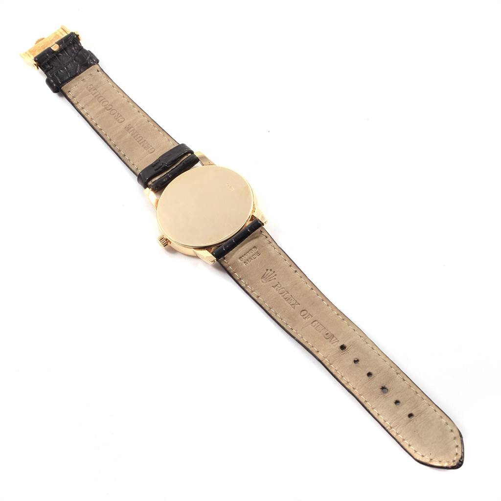 The image shows the back and straps of a Rolex Cellini 5116 Men's Yellow Gold Grey Dial 5116 Men's Yellow Gold Grey Dial watch laid flat, displaying the leather band and gold casing.