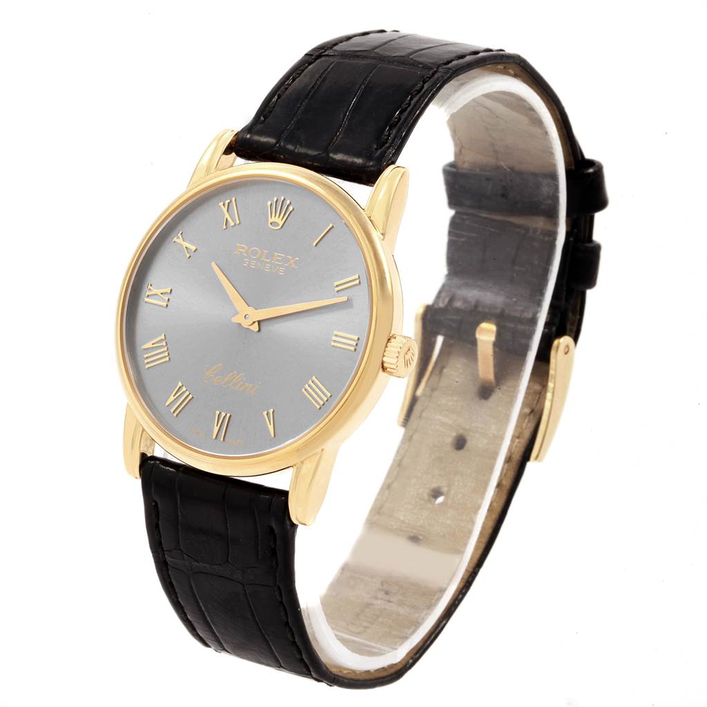 The Rolex Cellini 5116 Men's Yellow Gold Grey Dial 5116 Men's Yellow Gold Grey Dial watch is shown at a three-quarter angle, displaying its dial, case, crown, and leather strap.