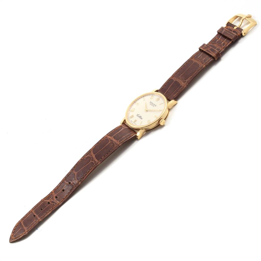 The image shows a Rolex Cellini 5115 Men's Yellow Gold Beige Dial 5115 Men's Yellow Gold Beige Dial watch at an angled top view, displaying the face, case, crown, and brown leather strap with a buckle.