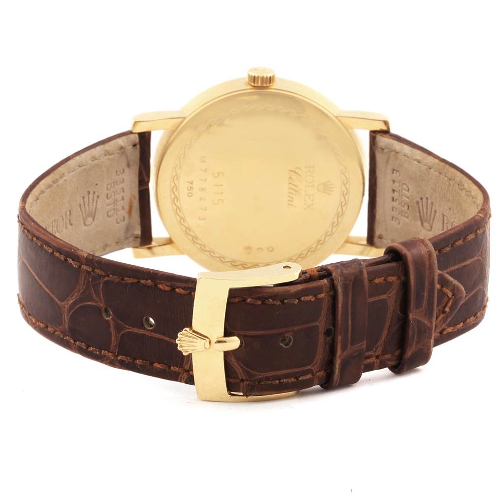 The image shows the back case and buckle of a Rolex Cellini 5115 Men's Yellow Gold Beige Dial 5115 Men's Yellow Gold Beige Dial watch, featuring a gold case and a brown leather strap.