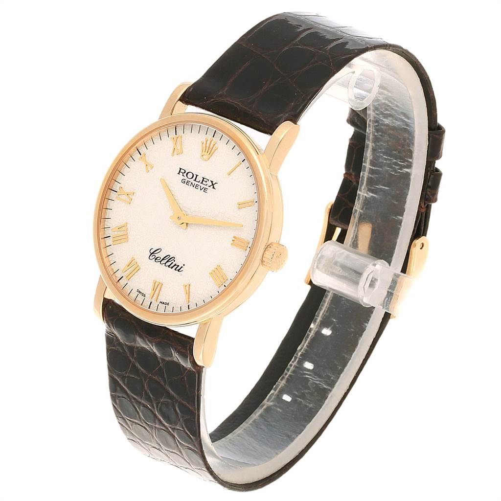 The Rolex Cellini 5115 Men's Yellow Gold Beige Dial 5115 Men's Yellow Gold Beige Dial watch is shown at a slight angle, displaying its face, gold case, and brown leather strap.