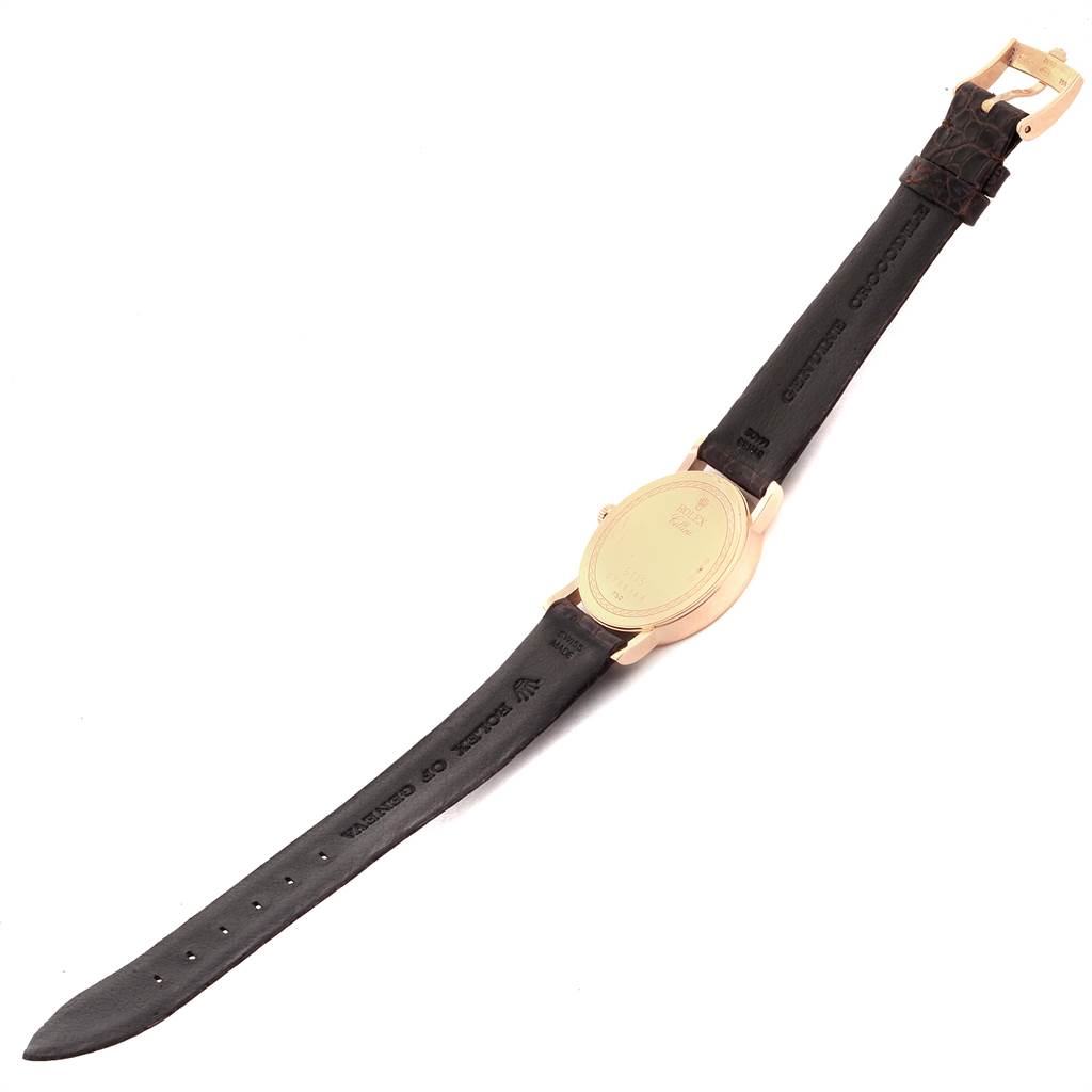 This image shows a Rolex Cellini 5115 Men's Yellow Gold Beige Dial 5115 Men's Yellow Gold Beige Dial watch from the back, emphasizing its gold case and black leather strap.