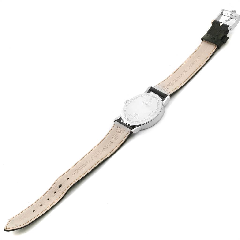 The Rolex Cellini 5115 Men
s White Gold Silver Dial 5115 Men
s White Gold Silver Dial watch is shown from the back with its case, straps, and clasp visible, highlighting the leather band.