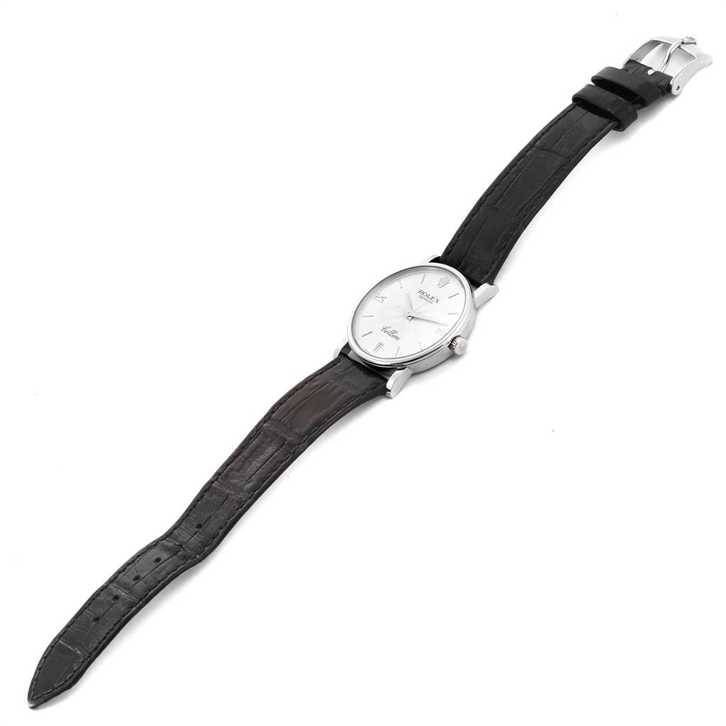 The Rolex Cellini 5115 Men
s White Gold Silver Dial 5115 Men
s White Gold Silver Dial watch is shown from an angled perspective, displaying the face, buckle, and leather strap.