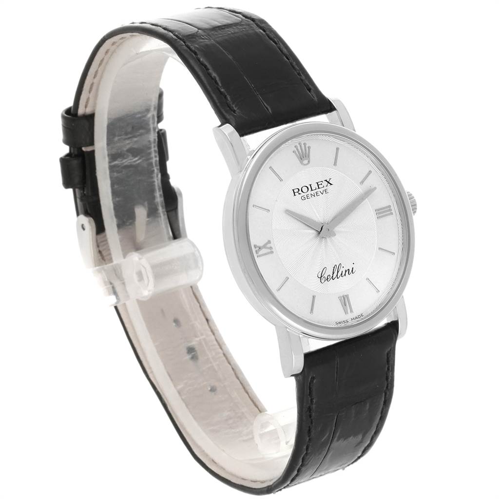 The image shows a Rolex Cellini 5115 Men
s White Gold Silver Dial 5115 Men
s White Gold Silver Dial watch from a front-side angle, featuring a black leather strap and a silver dial.