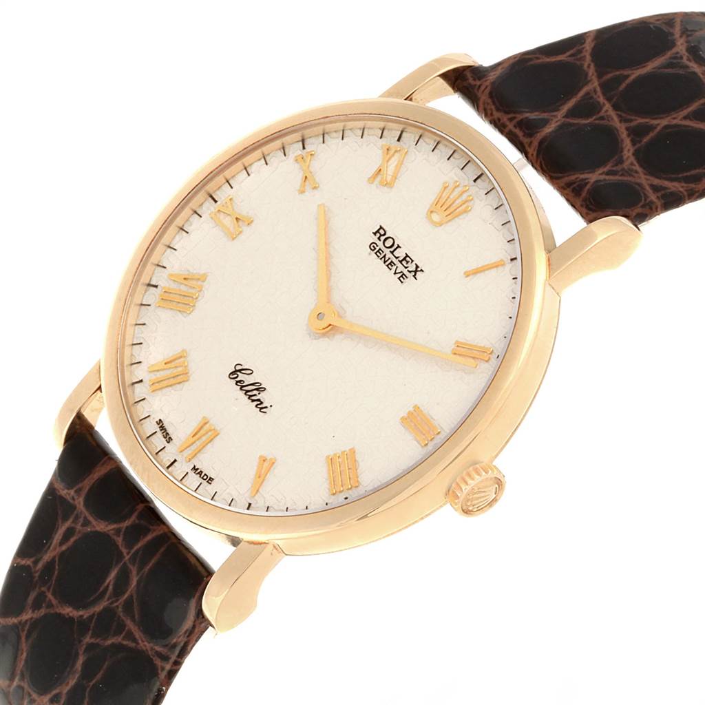 The Rolex Cellini 5112 Men's Yellow Gold Beige Dial 5112 Men's Yellow Gold Beige Dial watch is shown at an oblique angle, highlighting the dial, case, crown, and leather strap.