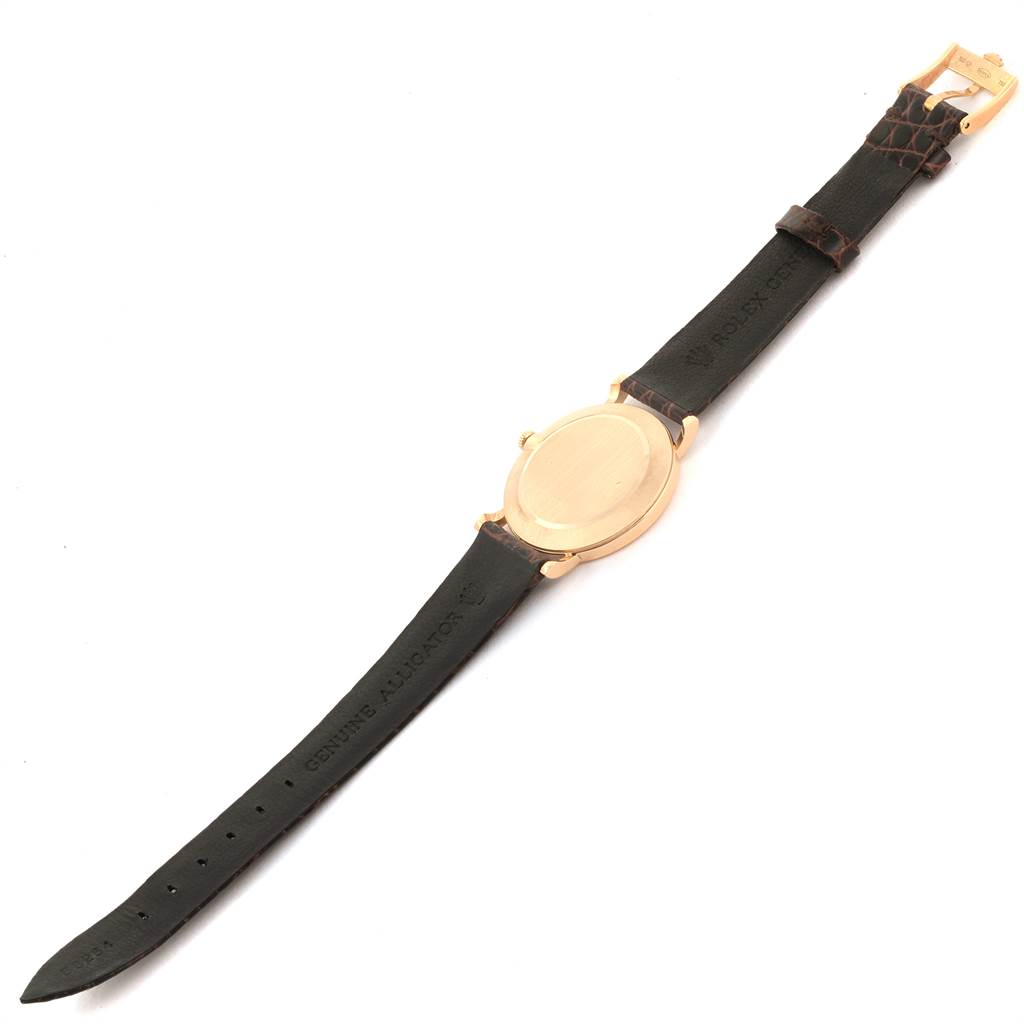 The image shows a Rolex Cellini 5112 Men's Yellow Gold Beige Dial 5112 Men's Yellow Gold Beige Dial watch from a top-down angle, highlighting its gold case and dark leather strap.