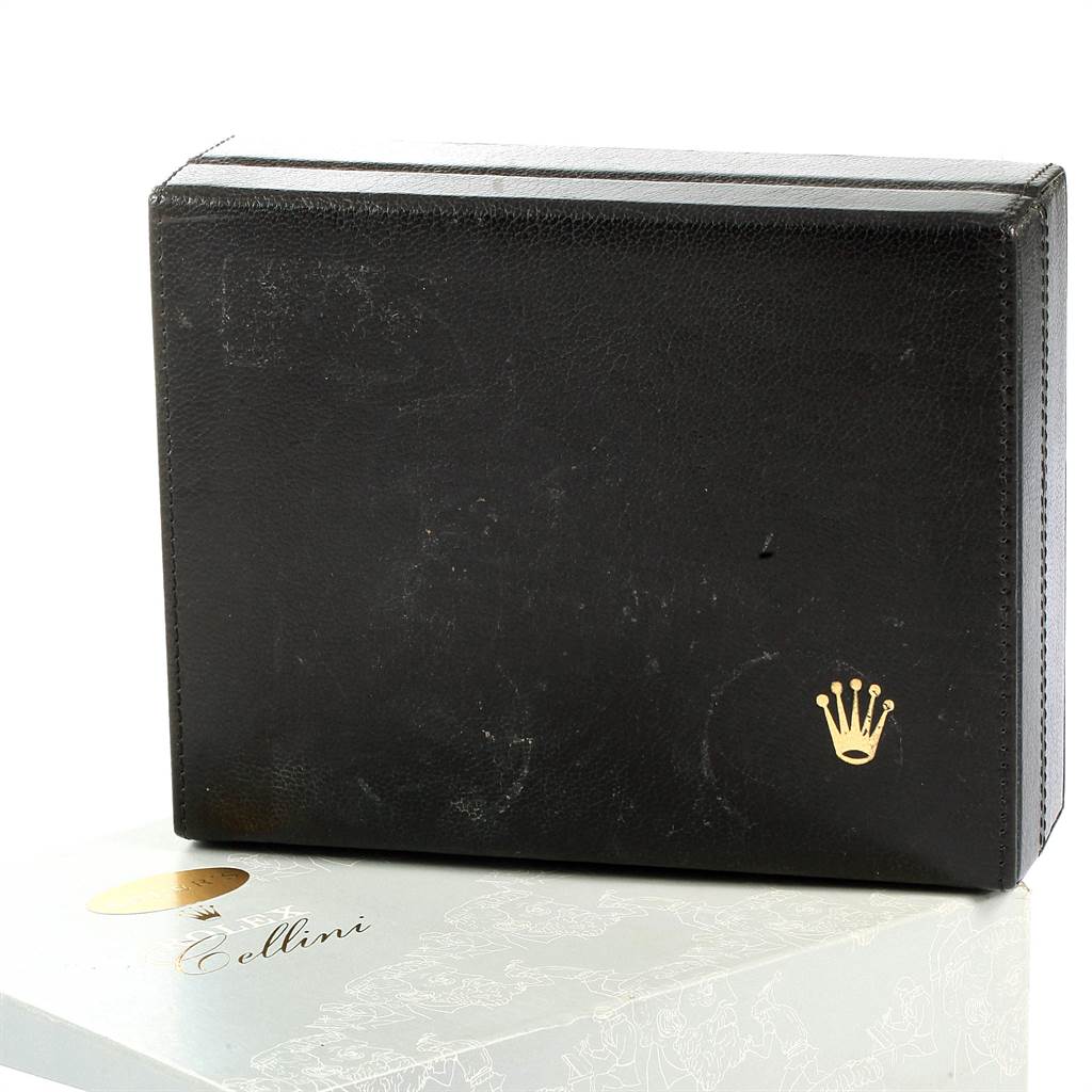 The image shows a close-up of a black Rolex Cellini 5112 Men's Yellow Gold Beige Dial 5112 Men's Yellow Gold Beige Dial watch box with a golden crown logo on it.
