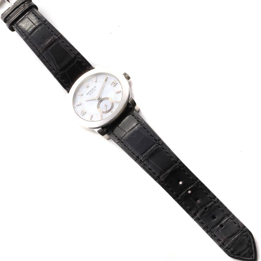 This image shows a top-down view of a Rolex Cellini 5240 Men's Platinum Mother of Pearl Dial 5240 Men's Platinum Mother of Pearl Dial watch, displaying its face, black leather strap, and side crown.