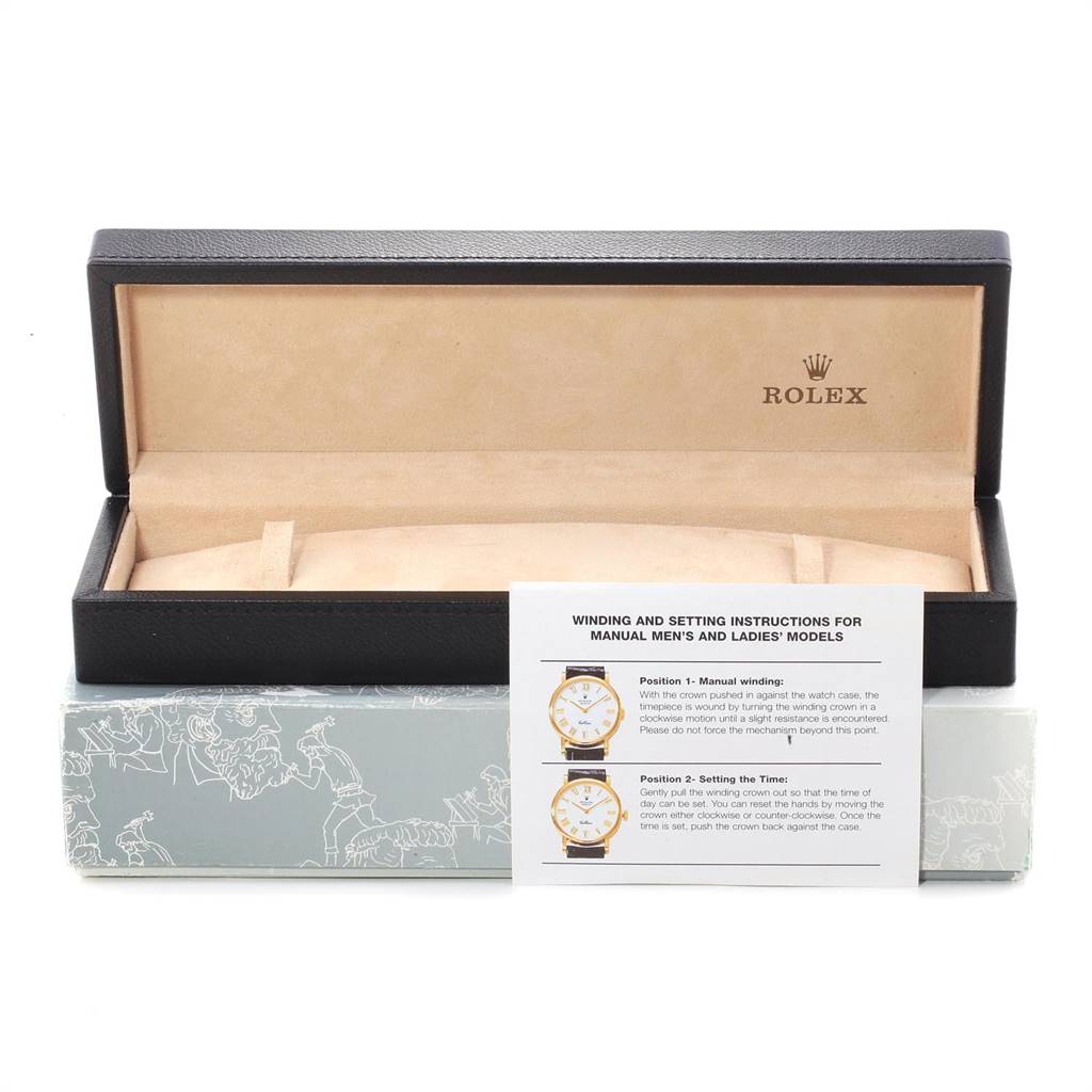 This image shows a Rolex Cellini 5240 Men's Platinum Mother of Pearl Dial 5240 Men's Platinum Mother of Pearl Dial watch's open box, displaying the interior and the instruction manual in front of it.