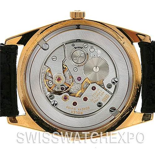 This image shows the back view of a Rolex Cellini 4233 Yellow Gold Black Dial 4233 Yellow Gold Black Dial watch, highlighting its exposed mechanical movement.