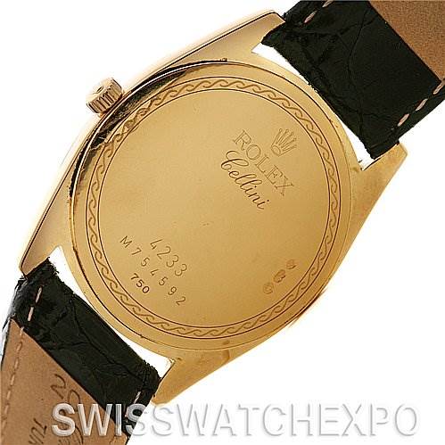 The image shows the back case of a Rolex Cellini 4233 Yellow Gold Black Dial 4233 Yellow Gold Black Dial watch, featuring engraved details and a black leather strap.