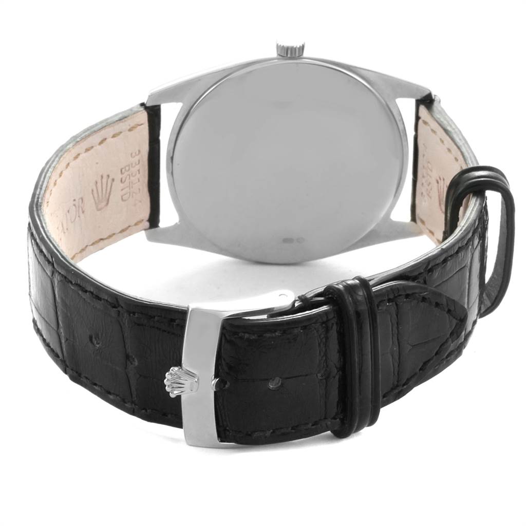 The image shows the back of a Rolex Cellini 4233 Men
s White Gold White Dial 4233 Men
s White Gold White Dial watch and its black leather strap, featuring the buckle and crown emblem.