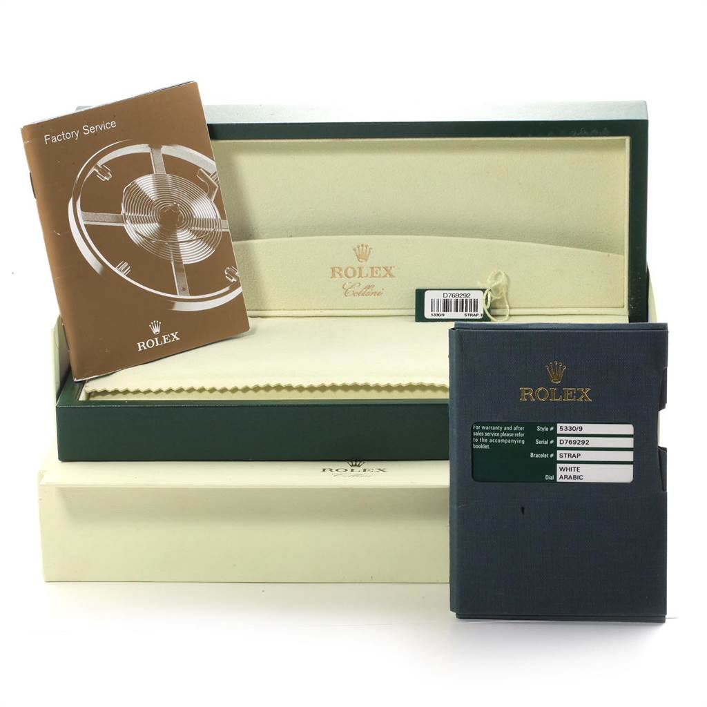 The image shows the open packaging, box, and booklets of a Rolex Cellini 5330 Men
s White Gold White Dial 5330 Men
s White Gold White Dial watch from a frontal angle.