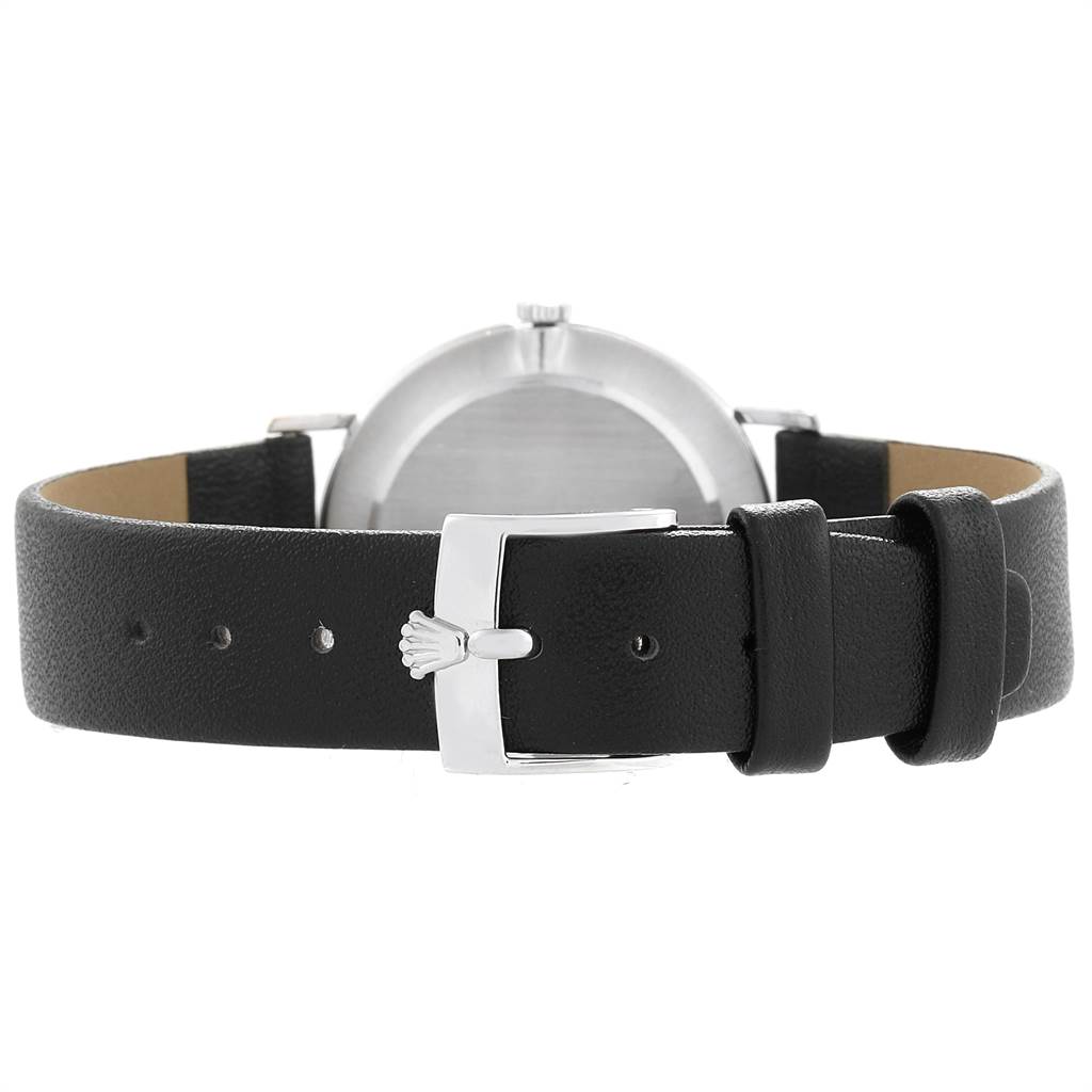 The image shows the back view of a Rolex Cellini 4112 Men
s White Gold Blue Dial 4112 Men
s White Gold Blue Dial watch with a black leather strap and silver buckle.