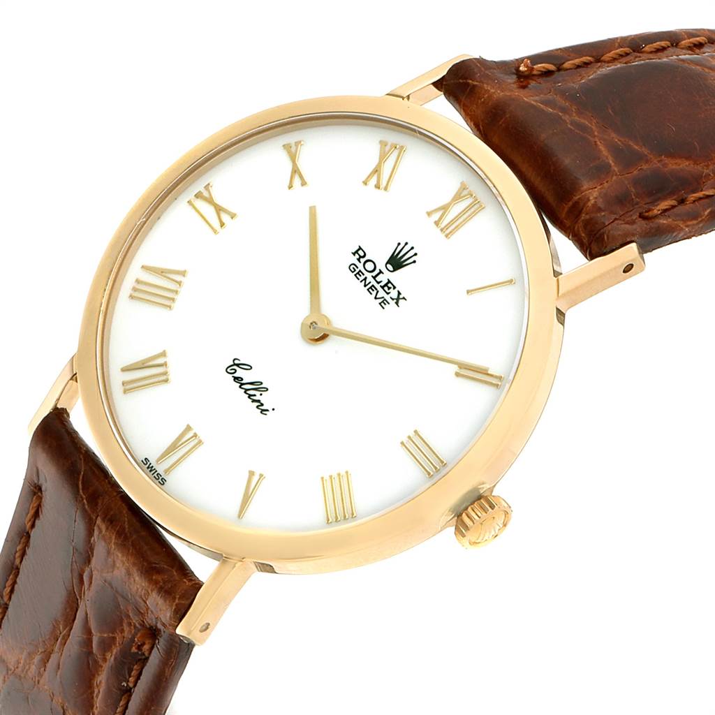 The Rolex Cellini 4112 Men
s Yellow Gold White Dial 4112 Men
s Yellow Gold White Dial watch is shown at an angled top view, displaying the face, crown, case, and leather strap.