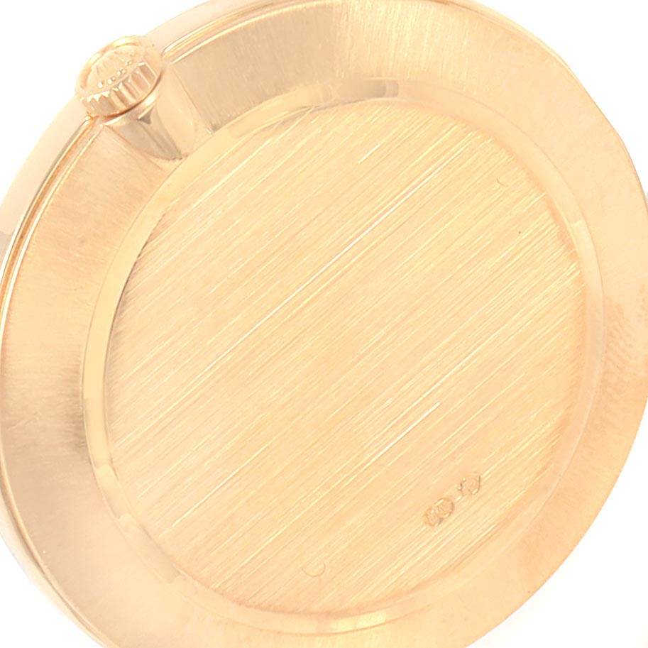 This image shows the back case and crown of a Rolex Cellini 4112 Men
s Yellow Gold White Dial 4112 Men
s Yellow Gold White Dial watch from an angled perspective.