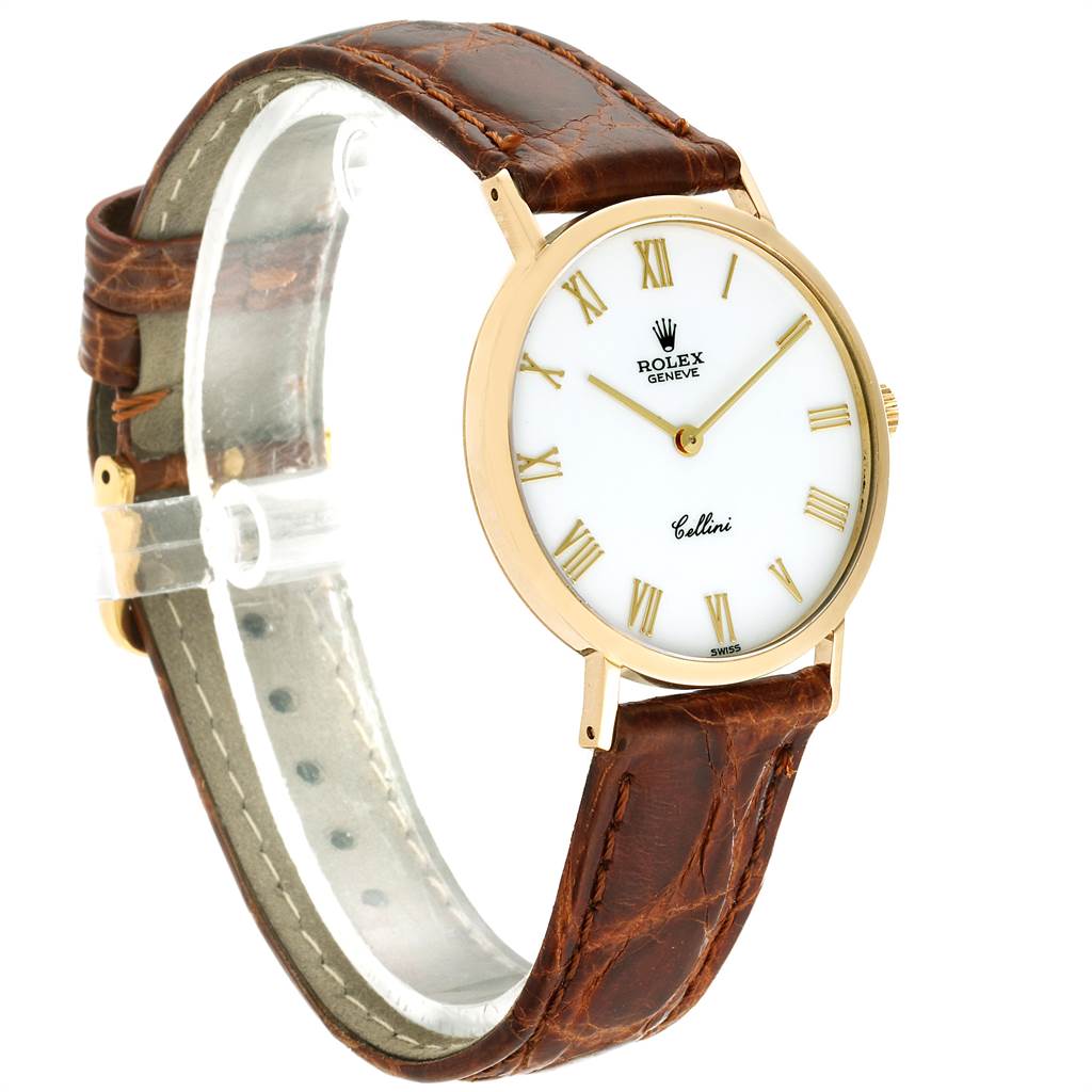 The Rolex Cellini 4112 Men
s Yellow Gold White Dial 4112 Men
s Yellow Gold White Dial watch is shown from a three-quarter angle, highlighting its white dial, brown leather strap, and gold case.