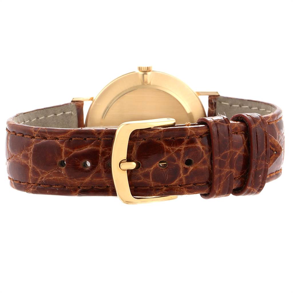 The image shows the back view of a Rolex Cellini 4112 Men
s Yellow Gold White Dial 4112 Men
s Yellow Gold White Dial watch, displaying its brown leather strap and gold buckle.