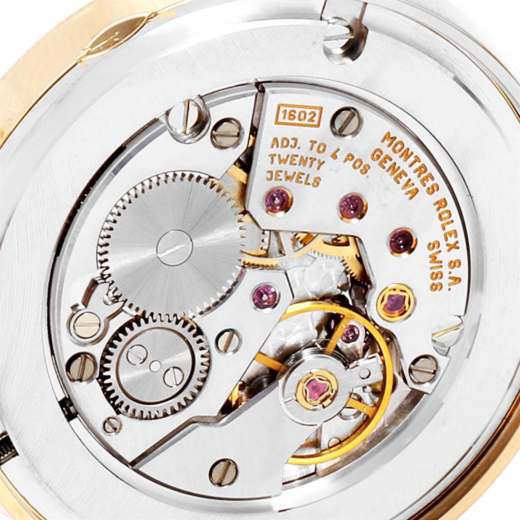 The image shows the intricate inner mechanism of a Rolex Cellini 5115 Men's Yellow Gold Black Dial 5115 Men's Yellow Gold Black Dial watch, focusing on its gears and jewels.