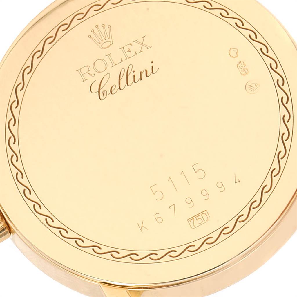 The image shows the back casing of a Rolex Cellini 5115 Men's Yellow Gold Black Dial 5115 Men's Yellow Gold Black Dial watch model, displaying engravings and the Rolex logo.