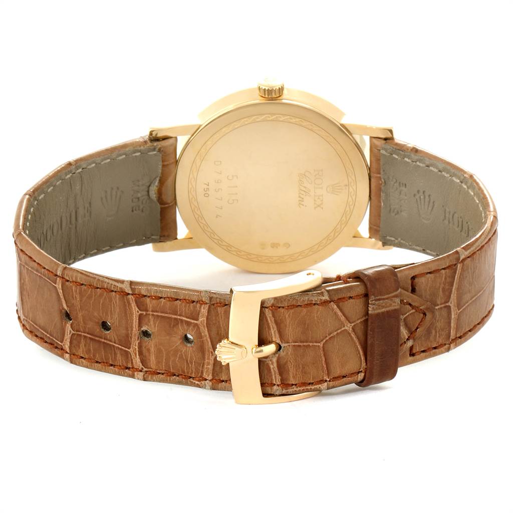 The image shows the back view of a Rolex Cellini 5115 Yellow Gold Mother of Pearl Dial 5115 Yellow Gold Mother of Pearl Dial watch, highlighting its case back, crown, and leather strap with a gold buckle.