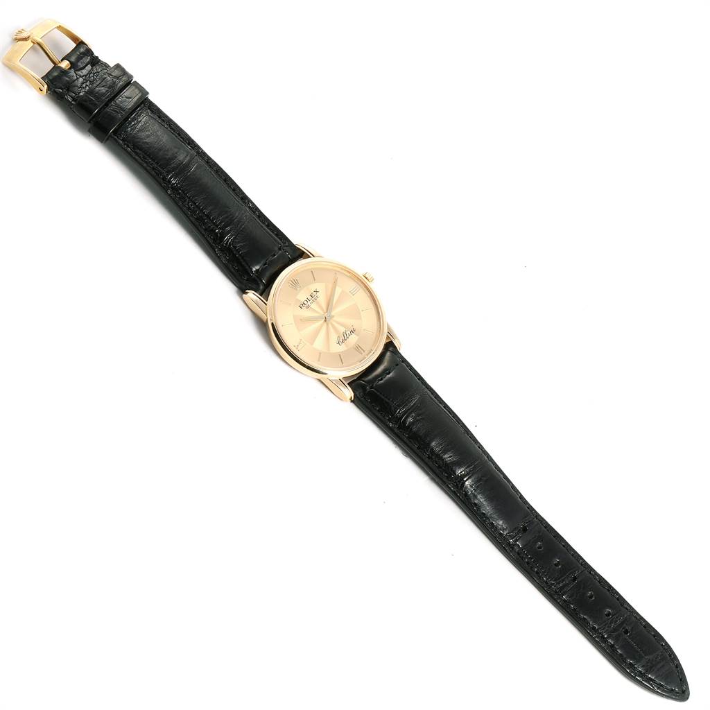The image shows a Rolex Cellini 5116 Men's Yellow Gold Champagne Dial 5116 Men's Yellow Gold Champagne Dial watch at a top-down angle, displaying its gold case and black leather strap.