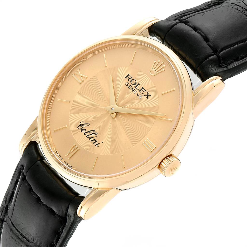 This image shows a Rolex Cellini 5116 Men's Yellow Gold Champagne Dial 5116 Men's Yellow Gold Champagne Dial watch at a slight angle, displaying its face, crown, and part of its black leather strap.