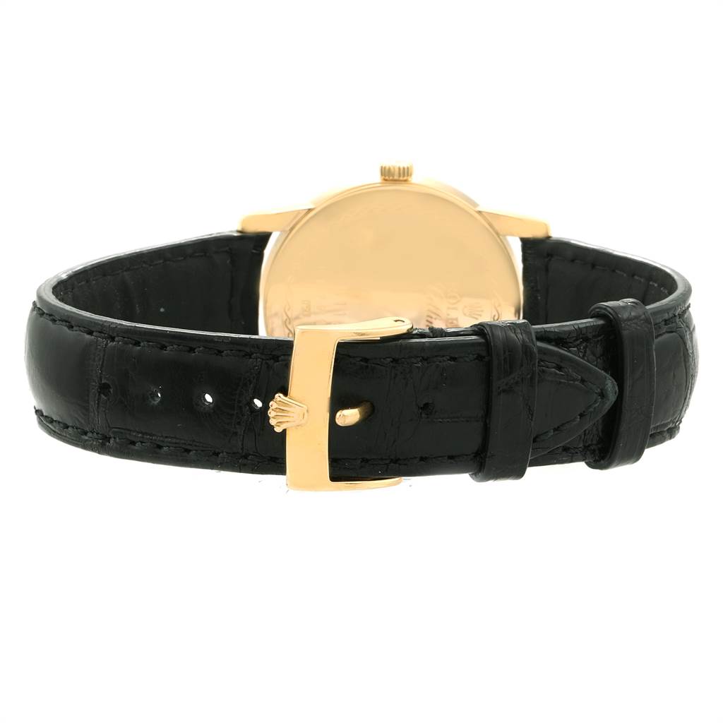 The image shows the back view of a Rolex Cellini 5116 Men's Yellow Gold Champagne Dial 5116 Men's Yellow Gold Champagne Dial watch, highlighting the black leather strap and gold buckle.