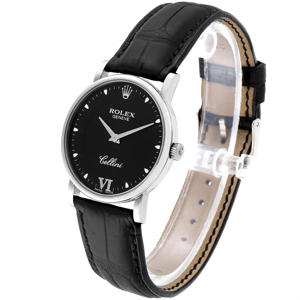 This Rolex Cellini 5115 Men
s White Gold Black Dial 5115 Men
s White Gold Black Dial watch is shown from a 3/4 angle, displaying its black dial, silver case, crown, and black leather strap.