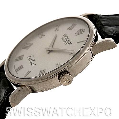 This image shows a side angle of the Rolex Cellini 5115/9 White Gold Silver Dial 5115/9 White Gold Silver Dial watch, highlighting its crown, case, and part of the leather strap.