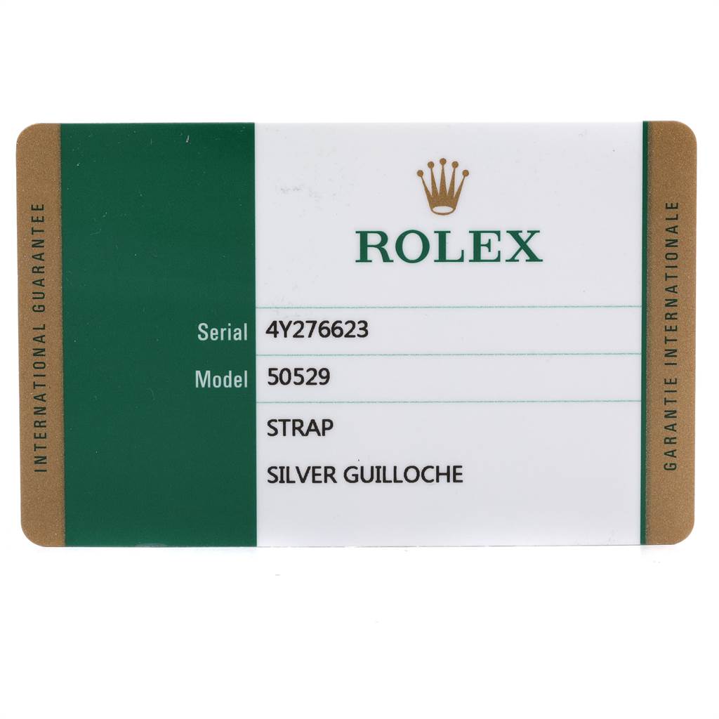 The image shows a warranty card for a Rolex Cellini 50529 Men
s White Gold Silver Dial 50529 Men
s White Gold Silver Dial model 50529 with a silver guilloche strap.