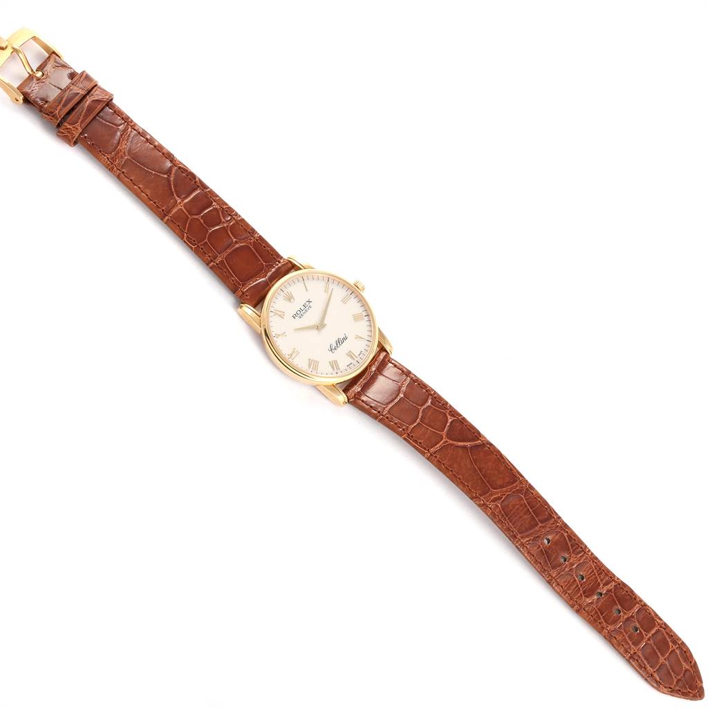 The watch is a Rolex Cellini 5116 Men's Yellow Gold Beige Dial 5116 Men's Yellow Gold Beige Dial model shown from a top-down view, displaying the entire watch and its brown leather strap.