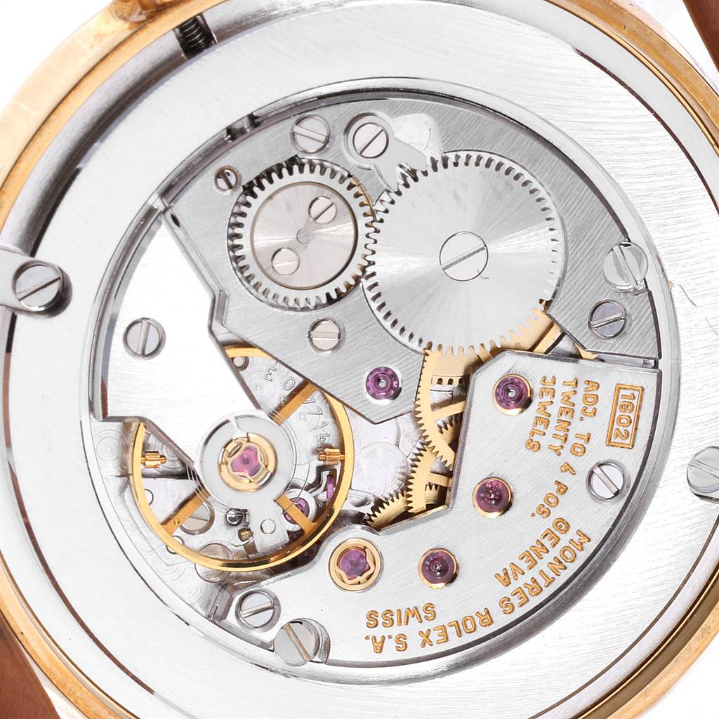 This image shows the intricate internal mechanics of a Rolex Cellini 5116 Men's Yellow Gold Beige Dial 5116 Men's Yellow Gold Beige Dial watch, including gears and jewels, taken from a direct top-down angle.